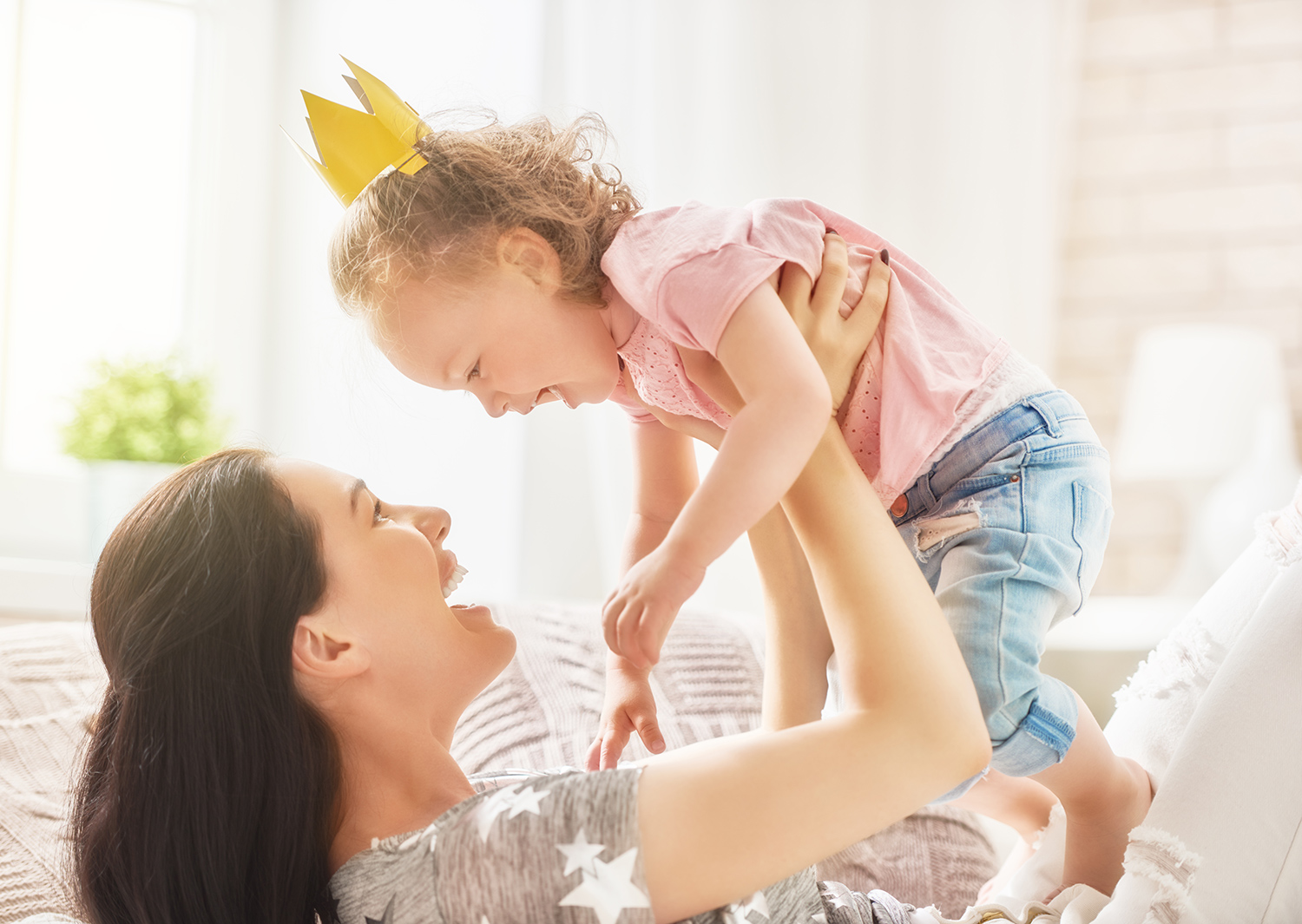 Mom Playing With Daughter in Bed.