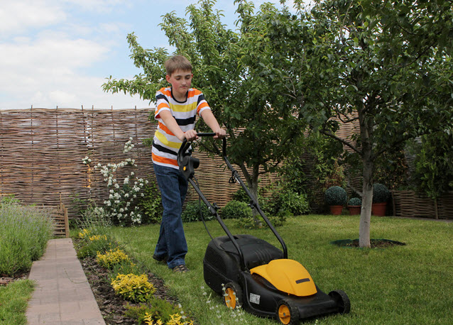 Boy Mowing Lawn.