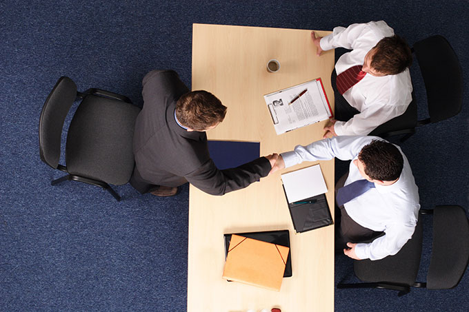 handshake over desk