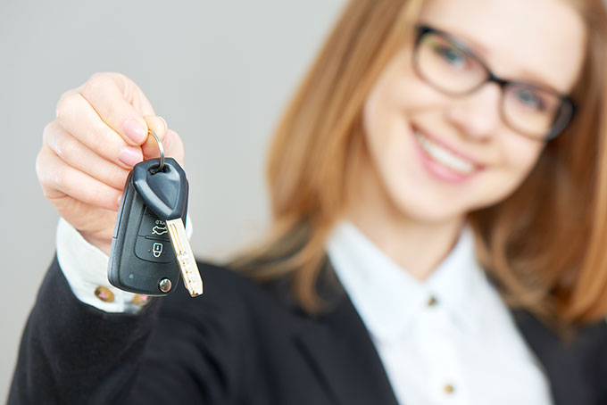 Womain Smiling Holding Car Keys.